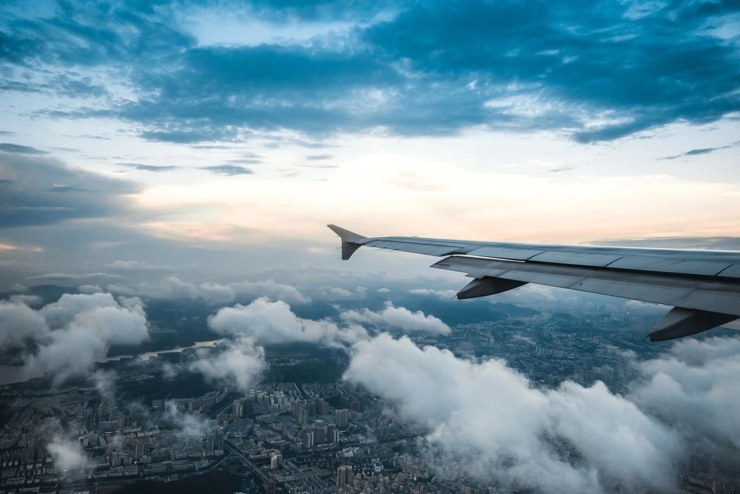 Aerial view from airplane wing over cityscape